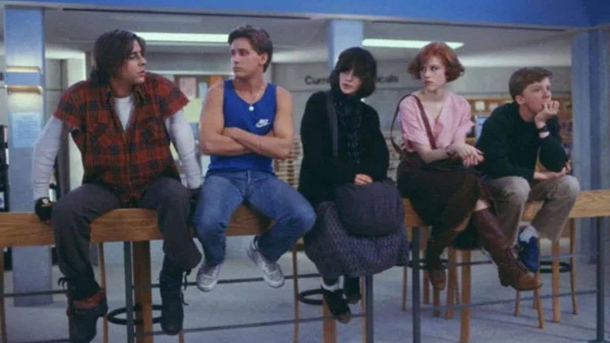 The Breakfast Club sitting in detention, chatting and looking bored.